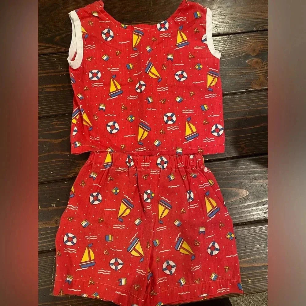 Vintage outfit from 1980s. Red with white trim. Has sailboats and anchors